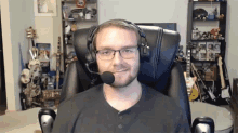 a man wearing glasses and headphones with a microphone