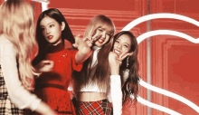 three girls are posing for a picture and one of them is pointing