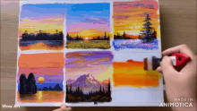 a person is painting a sunset on a piece of paper