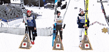 three skiers are standing on a podium with one wearing a shirt that says wurth