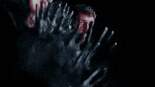 a bunch of hand prints on a black surface