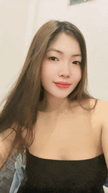 a woman with long brown hair is taking a selfie
