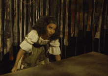 a woman in a green dress holds a tray of chocolate