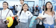 a group of people standing next to each other with their eyes closed and smiling
