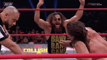 two men are wrestling in a ring and one of them is wearing a shirt that says bang bang gang .