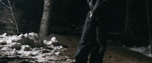 a person is standing in the snow in the dark