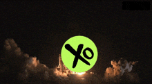 a green circle with a black x on it is in front of a rocket