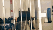 a man is doing exercises on a machine with a fire extinguisher behind him