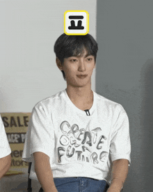 a young man wearing a white t-shirt that says create future