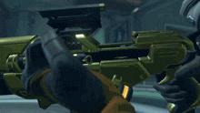 a close up of a person holding a gun with a yellow glow