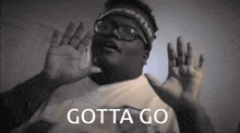 a man wearing glasses and a headband with the words gotta go on it