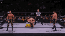 a referee stands between two wrestlers in a ring that says draft