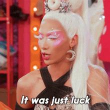 a woman with white hair says it was just luck in white letters