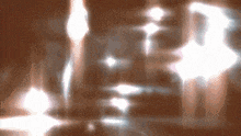 a blurred image of a person 's face with a few lights behind it