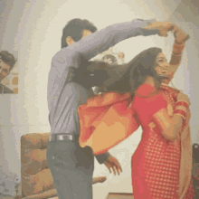 a man and a woman are dancing together in a room