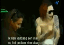 a man and a woman are standing next to each other and the man is wearing sunglasses