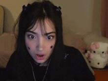 a girl with a hello kitty behind her