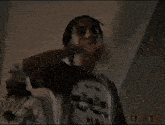 a man in a white shirt is pointing at the camera .