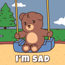 a teddy bear is sitting on a swing with the words " i 'm sad " above him