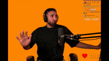 a man wearing headphones stands in front of a microphone with a heart and the number 107