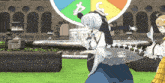 a woman in a blue dress is dancing in front of a rainbow colored circle with the letter c on it