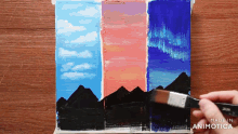 a person is painting a sunset with a brush and the words made in animatica are on the bottom