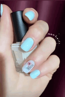 a woman holds a bottle of muse nail polish on her finger