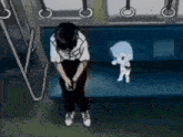 a man is sitting on a couch next to a small white dog .
