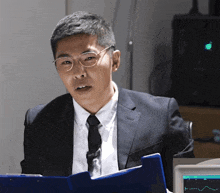 a man in a suit and tie is holding a clipboard with a graph on it