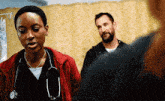 a man and a woman are standing in a hospital room .