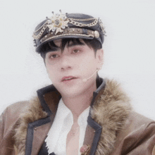 a man wearing a hat and a fur coat looks at the camera
