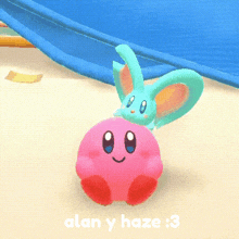 a pink kirby with a blue bunny on top of it and the words alan y haze : 3