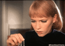 a close up of a woman 's face with the hashtag evanaboutcinema