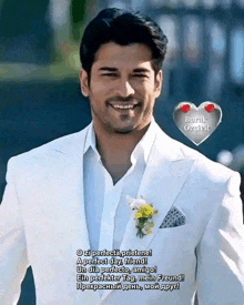 a man in a white suit is smiling and has a flower in his pocket ..