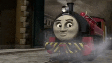 a cartoon train is going down the tracks in a city .