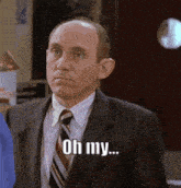 a bald man in a suit and tie is saying oh my