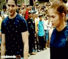 a man and a woman are standing next to each other in front of a crowd and the word dubmode is on the bottom left