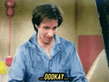 a man in a blue shirt says " oookay "