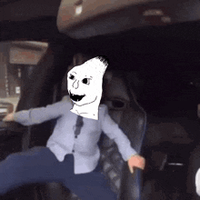 a man in a car with a cartoon character on his head