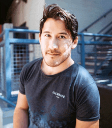 a man wearing a black t-shirt with the word illusive on the front