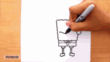 someone is drawing spongebob on a piece of paper with a sharpie marker