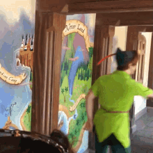 a man in a peter pan costume is standing in front of a painting that says never land