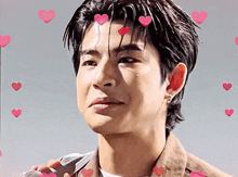a close up of a man 's face with hearts floating around him .