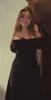 a woman in a black dress is dancing with colorful dots on her face