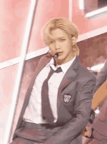 a man in a suit and tie is standing on a stage .