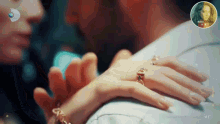 a woman wearing a ring on her finger is holding a man 's hand