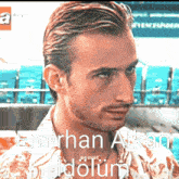 a close up of a man 's face with the words emirhan alkan idolum written below him