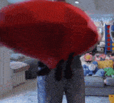 a person in a living room with stuffed animals on the floor
