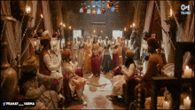 a group of people are gathered in a room with candles and the words pranay varma on the bottom