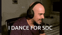 a man wearing headphones says " i dance for sdc " in white letters